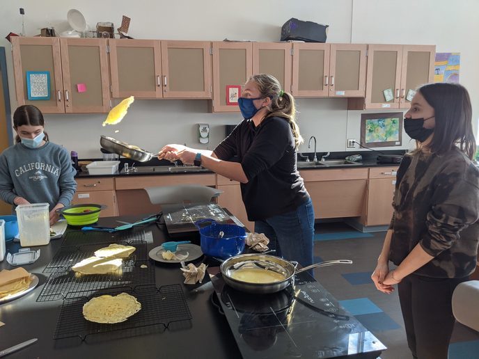 Students flip crepes